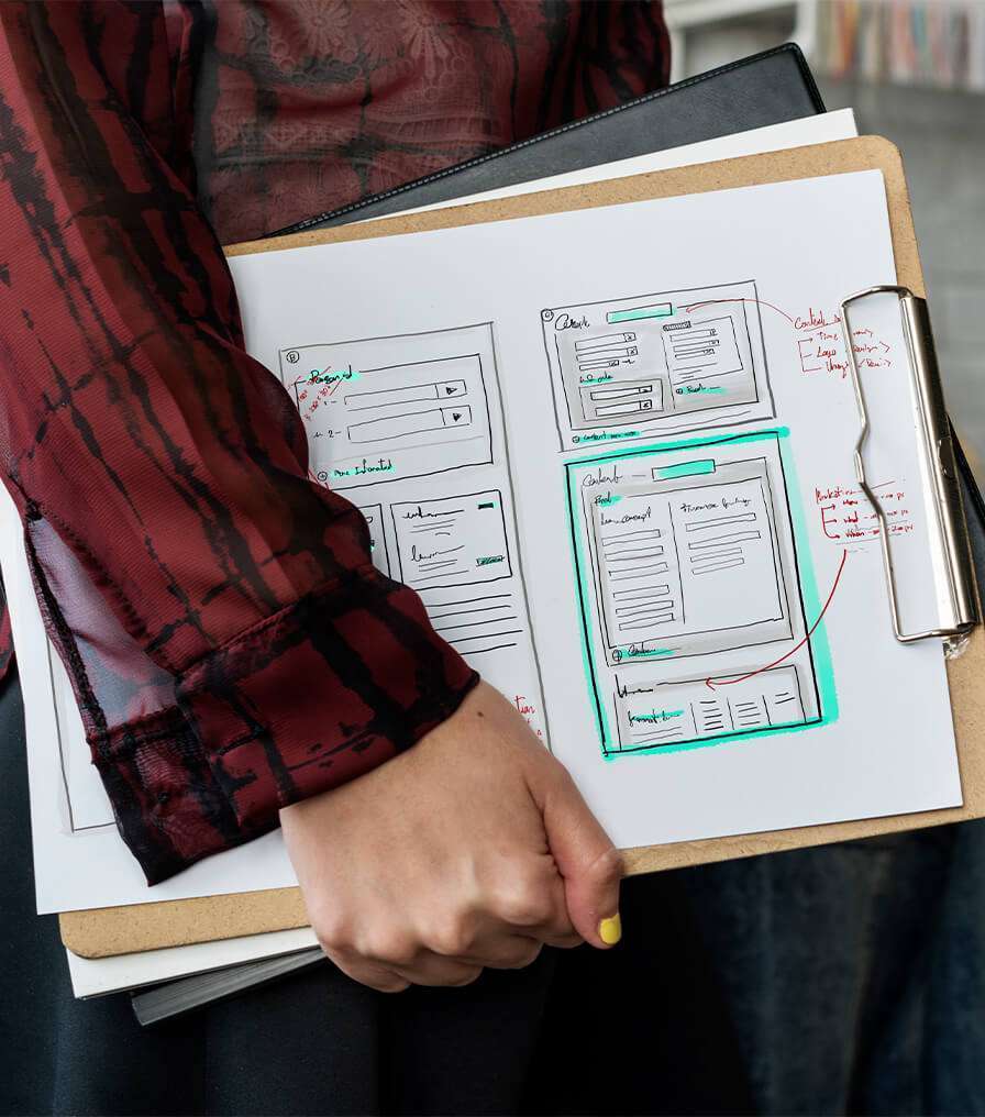 A woman with a clipboard featuring a design, showcasing 911MYWEB Web Development Solutions.
